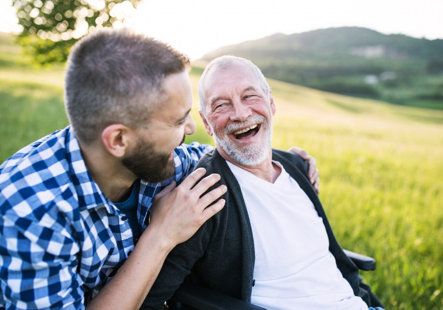Dad and son laughing in field